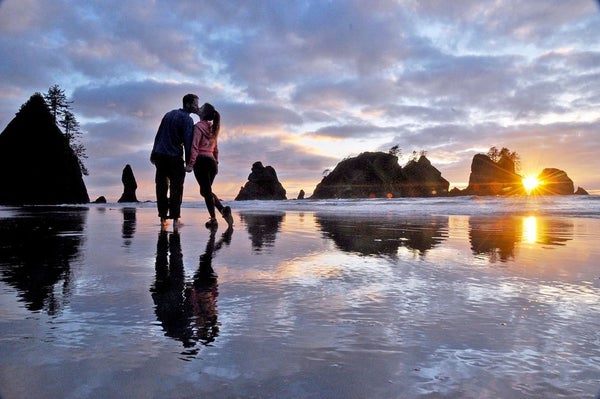 A couple on the beach by the water